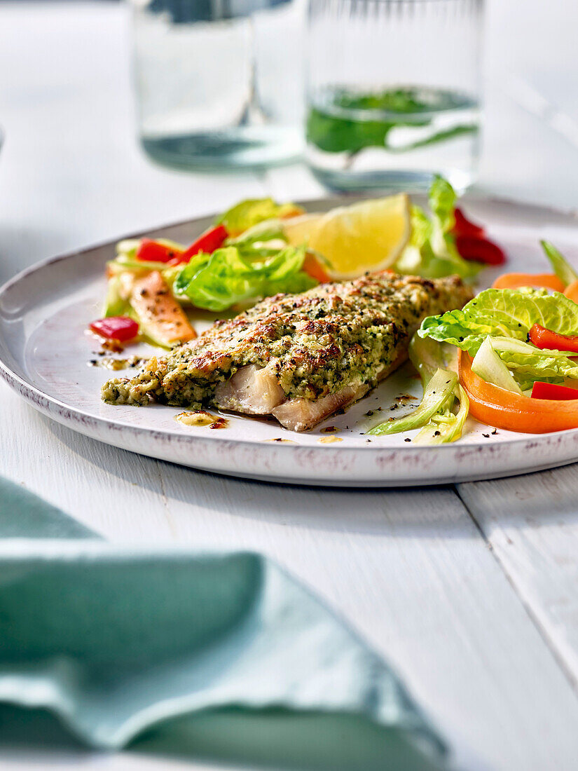 Fish fillet with herb crust and salad