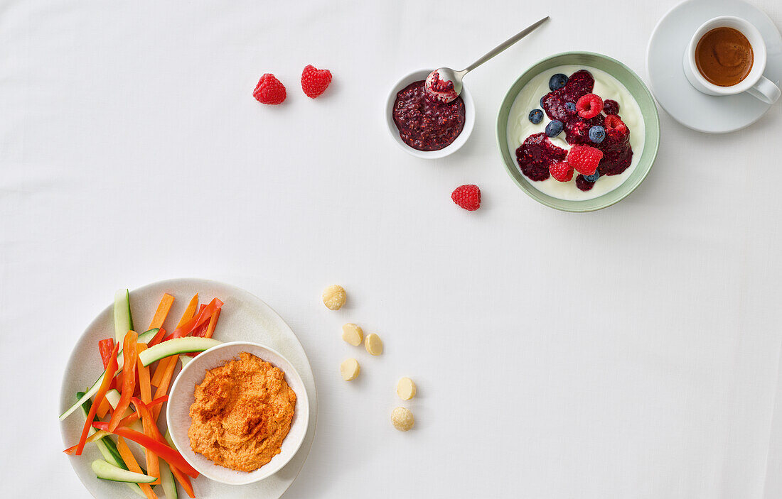 Breakfast with berry yoghurt and vegetable sticks with dip