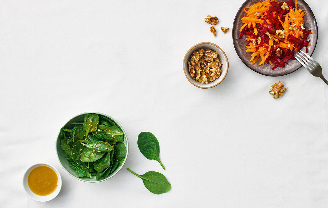 Spinach salad with sesame seeds and colourful beetroot salad