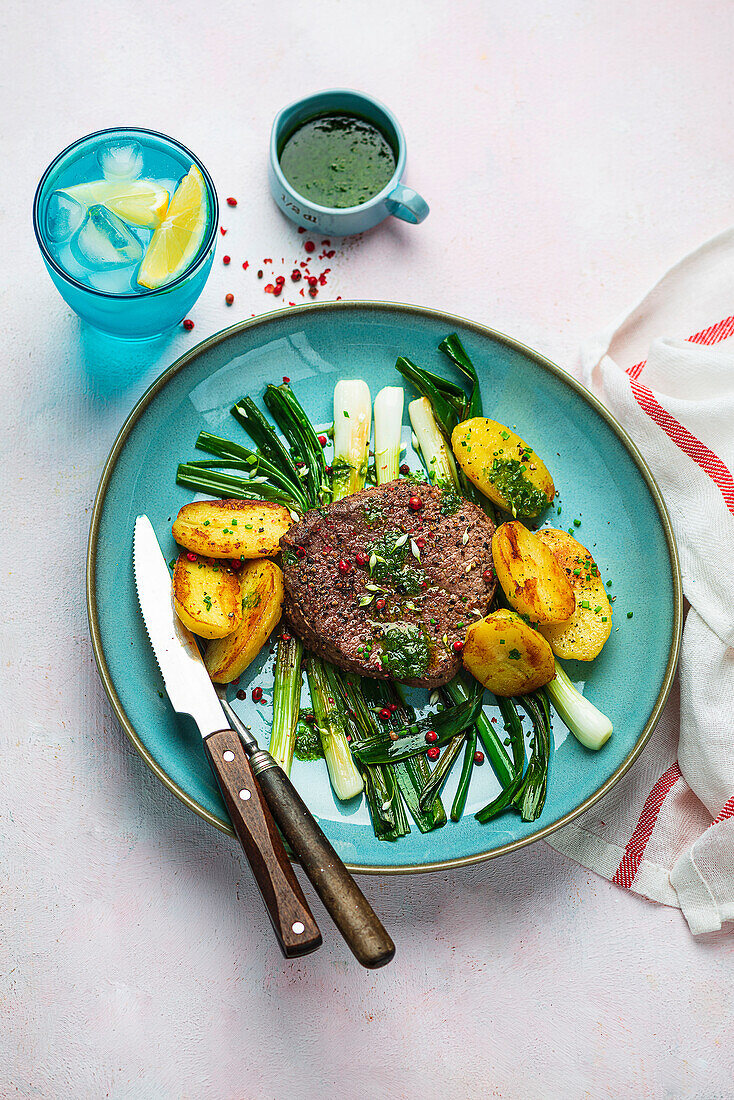 Beef steak with roast potatoes and spring onions