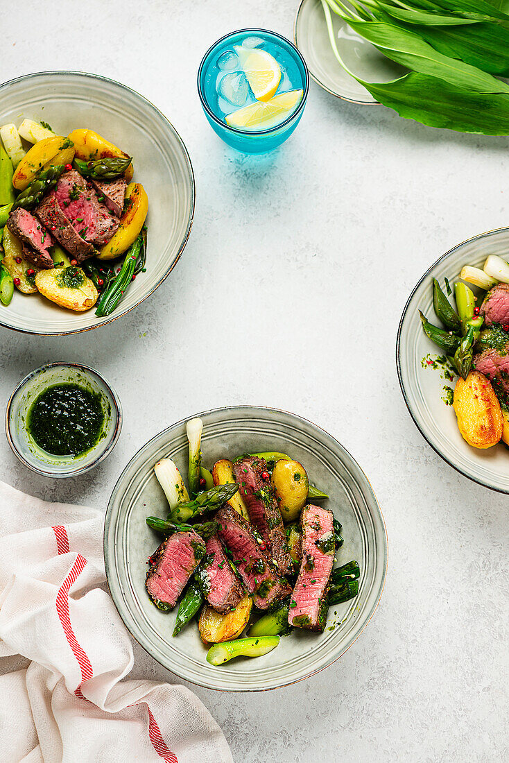 Beef steak with wild garlic oil and spring vegetables