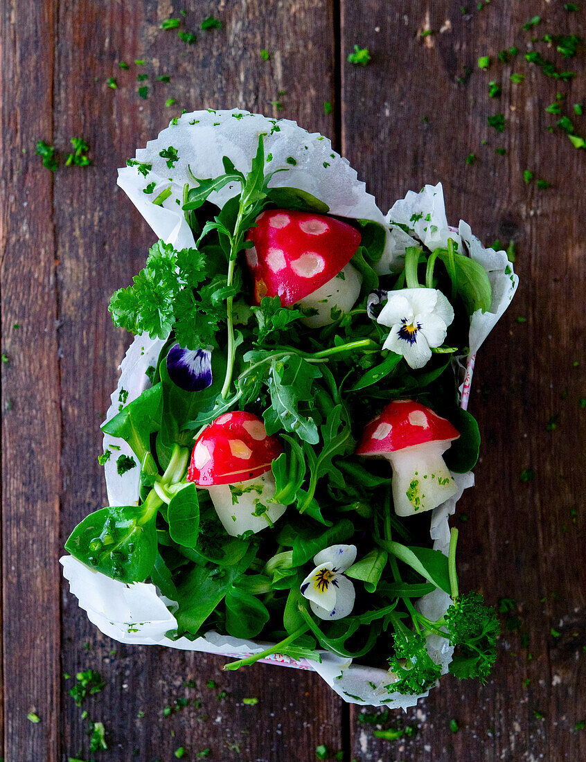 Radish salad with toadstool decoration and edible flowers
