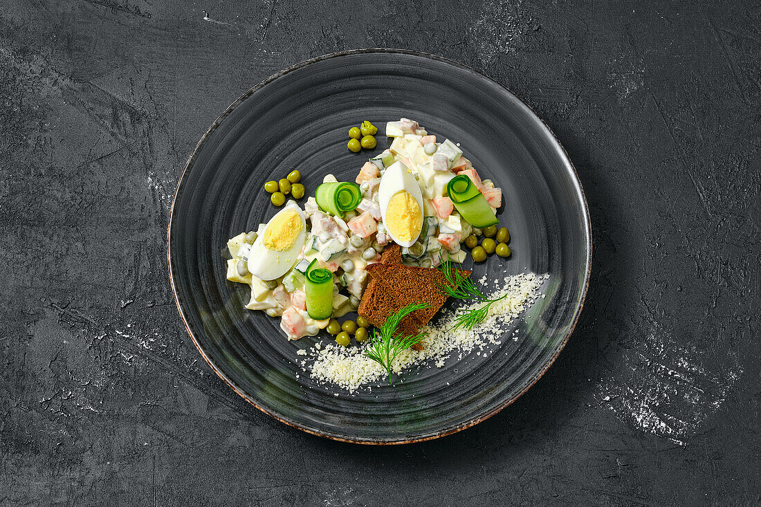 Olivier salad with egg and brown bread