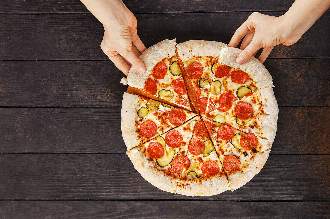 Pizza with salami and gherkins