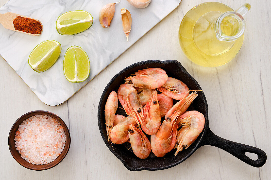 Prawns in cast iron pan with lime and spices