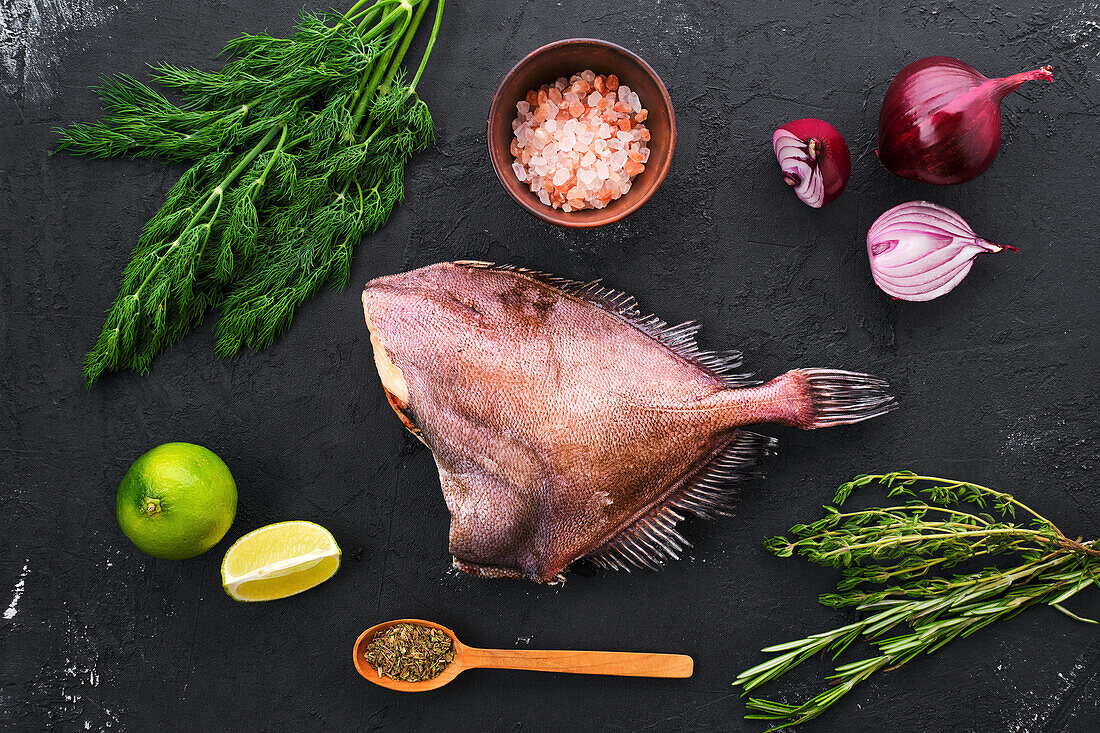 Raw sea bream fish with dill and herbs