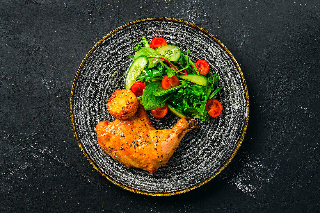 Baked chicken leg with fresh salad and sweetcorn