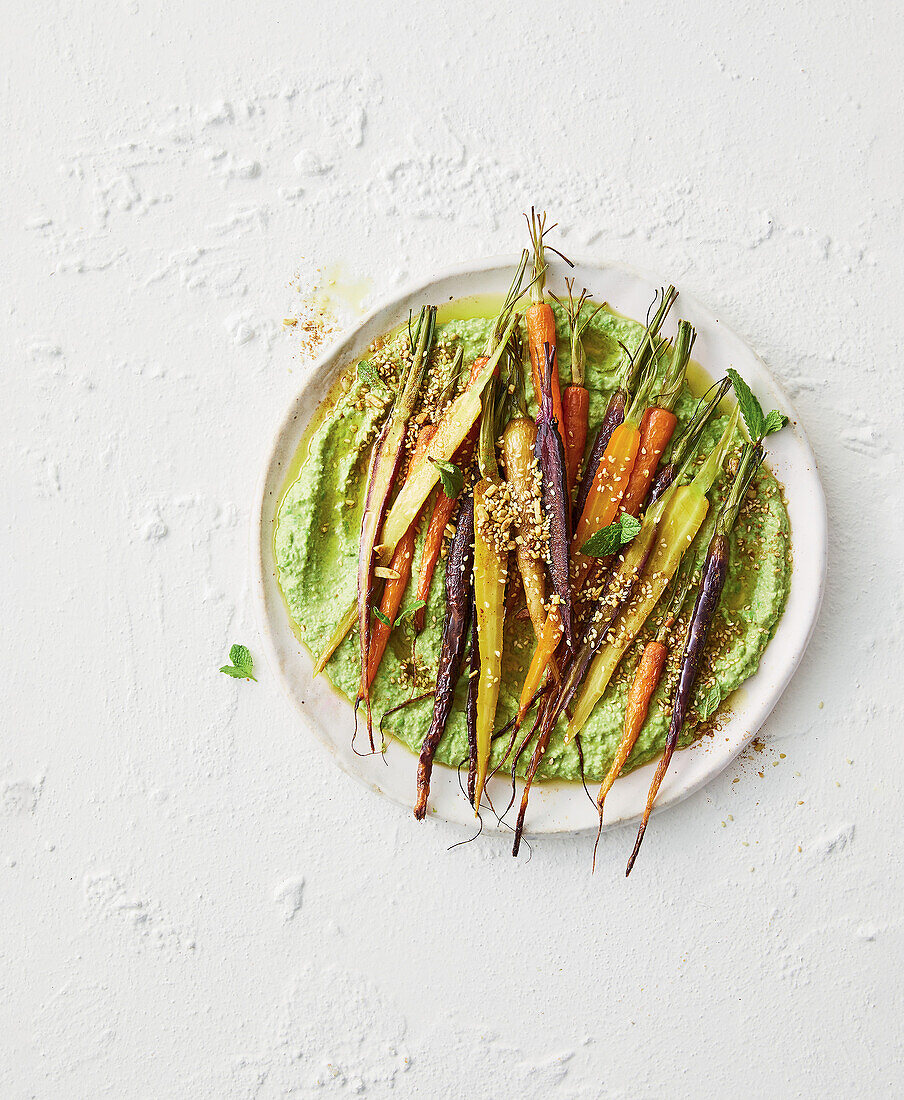 Roasted rainbow carrots with pea hummus