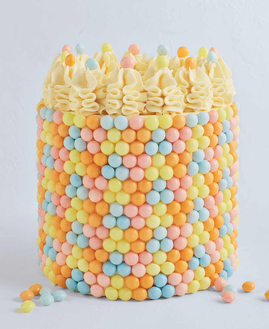 Colourful layer cake with sugar pearl decoration