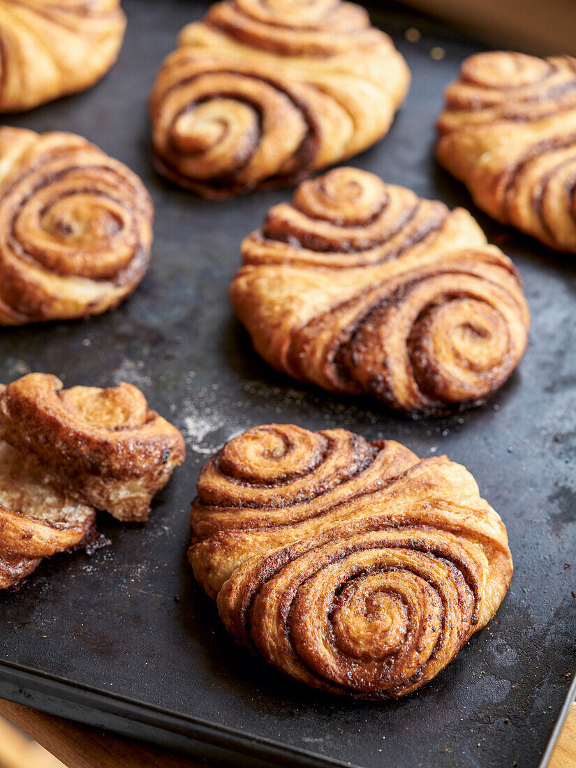 Freshly baked Franzbrötchen on a baking tray