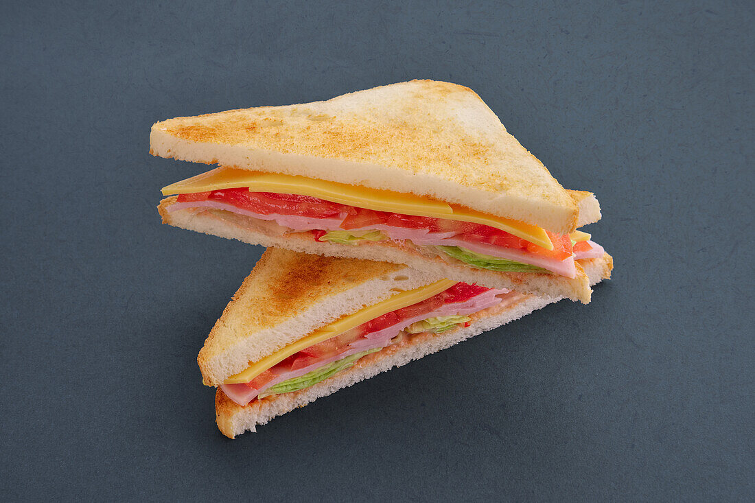 Club sandwich with cheese, ham and cucumber