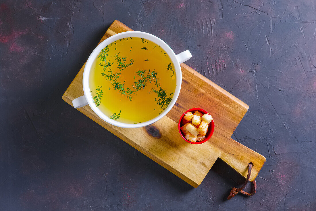 Chicken broth with herbs and croutons