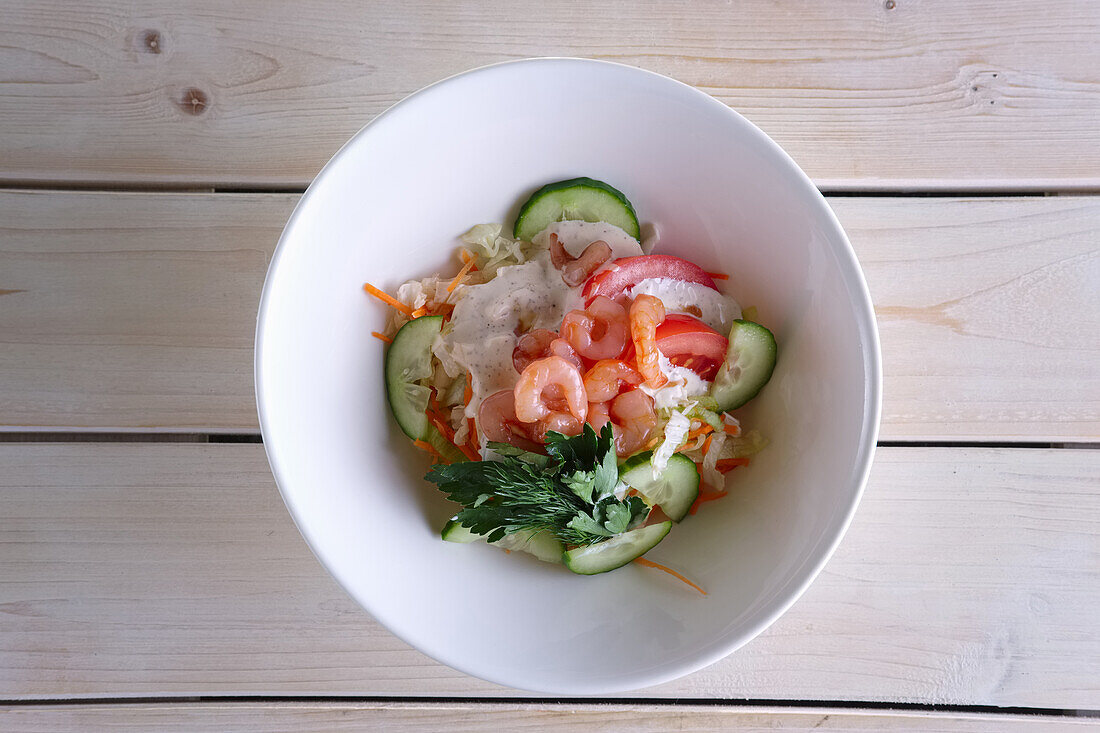 Salad with prawns, tomatoes, cucumber and mayonnaise