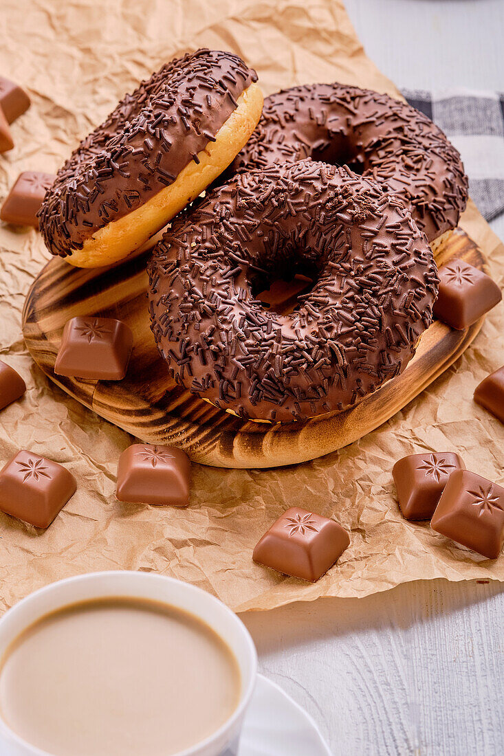 Chocolate donuts with chocolate sprinkles and pralines