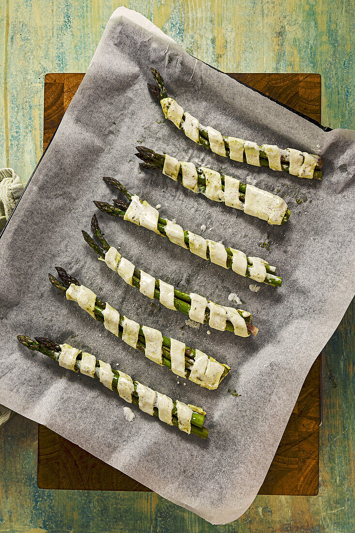 Asparagus wrapped in puff pastry before baking