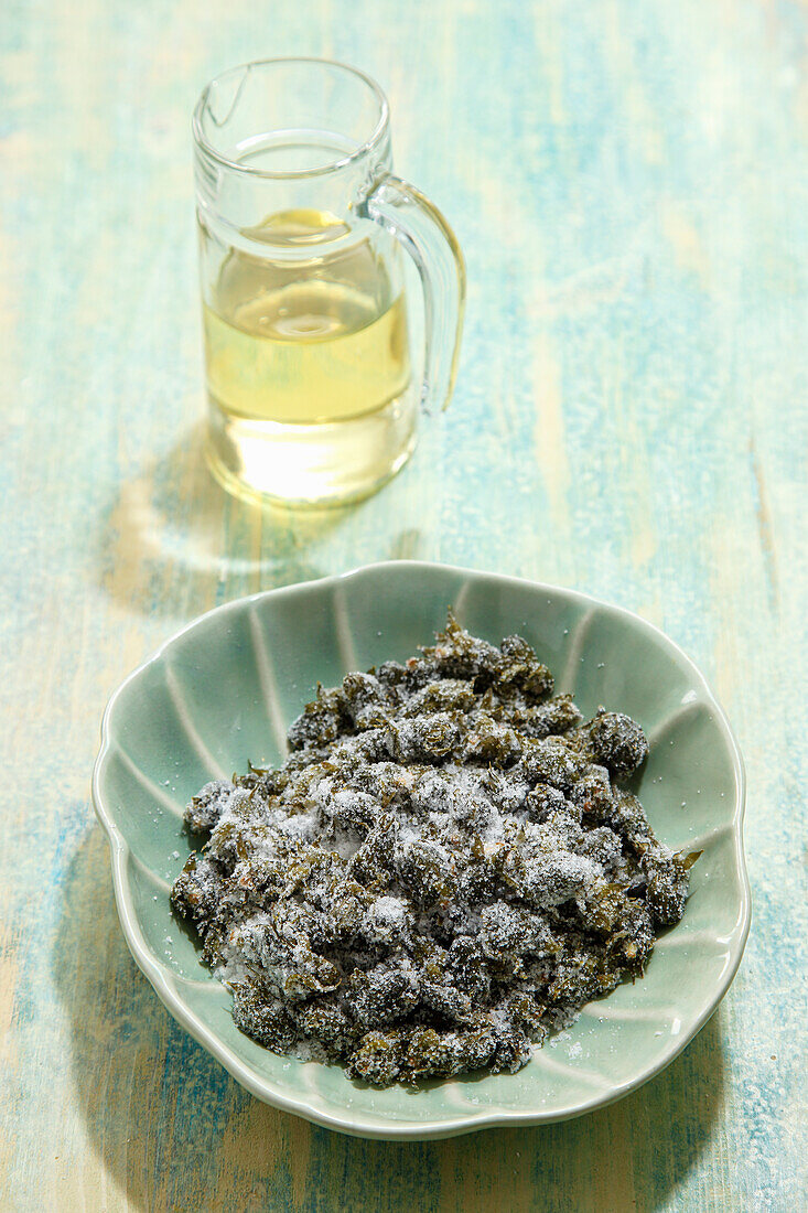 Preparing dandelion capers; dandelion buds with vinegar and salt