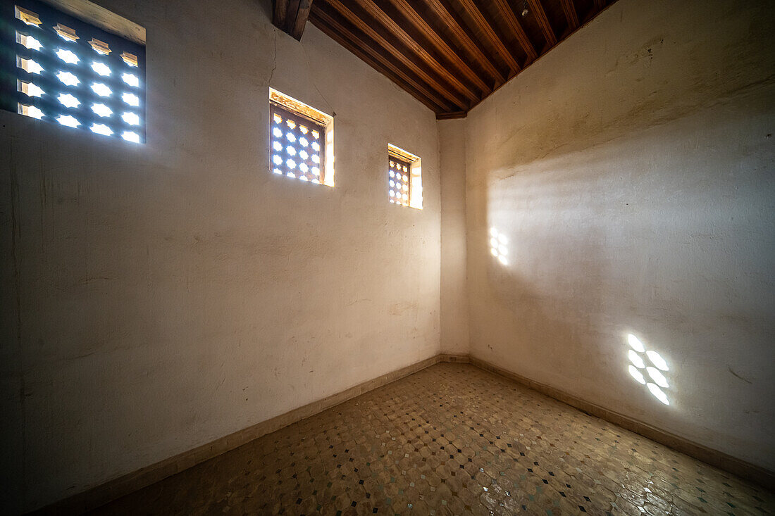 A tranquil view captures the essence of Fez through the ornate window of Cherratine Madrasa. Fez, Morocco.