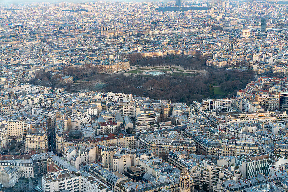 Luxembourg Gardens stand out among the Paris cityscape as evening approaches.