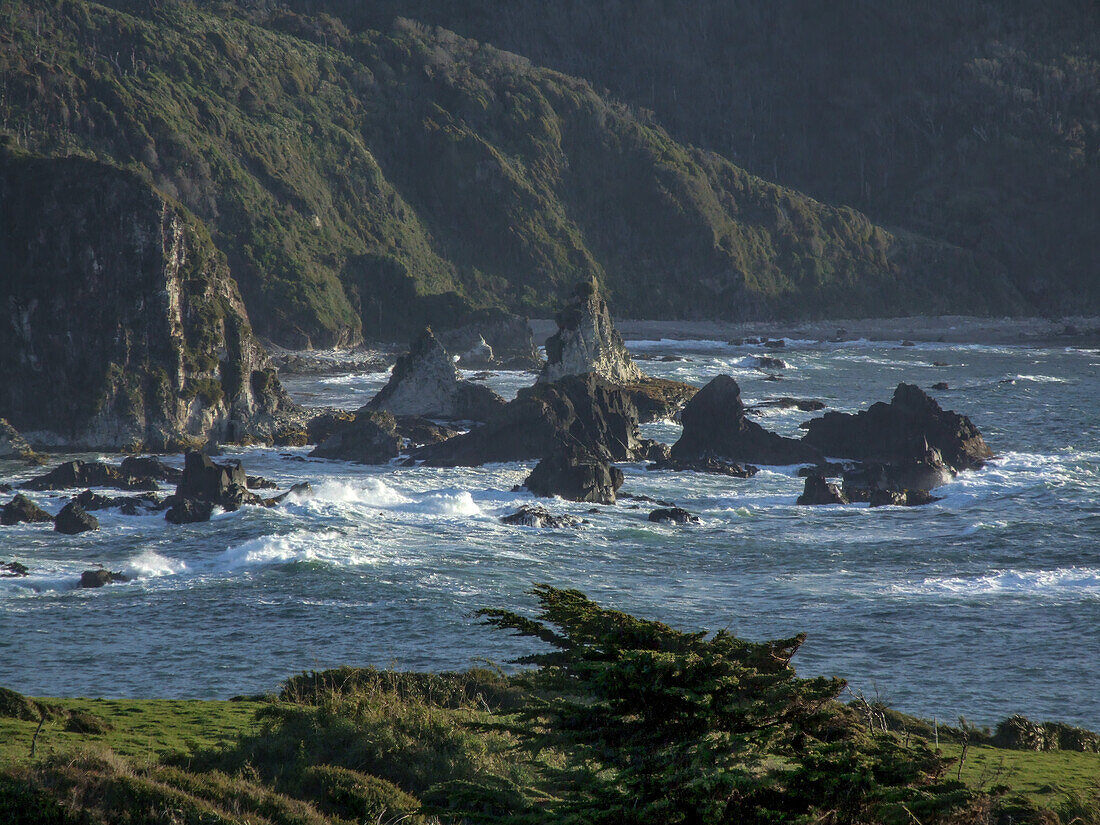 Rocks in the Pacific Ocean off the western shore of Chiloe Island in the Lakes Region of Chile.