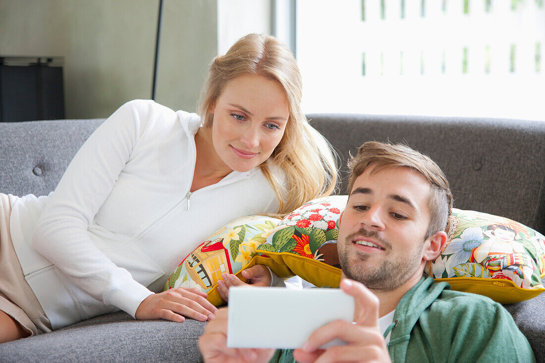 Couple on Sofa Using Smartphone