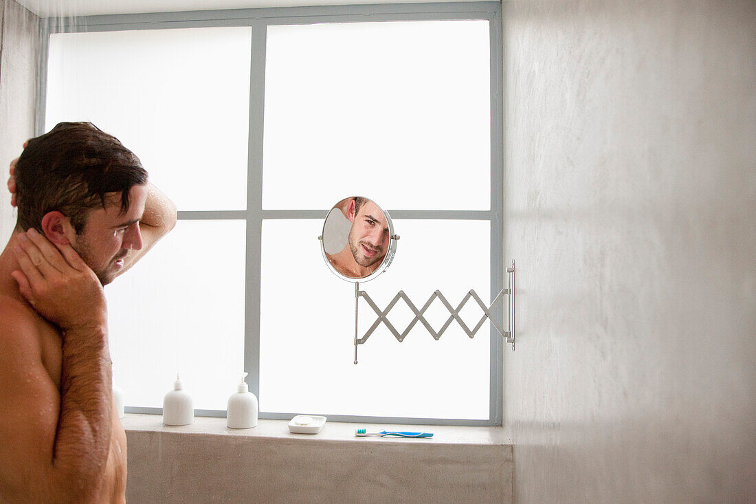 Man under Shower Looking in Mirror