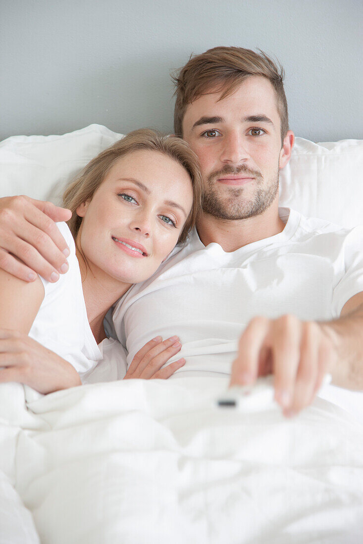 Couple in Bed Watching TV