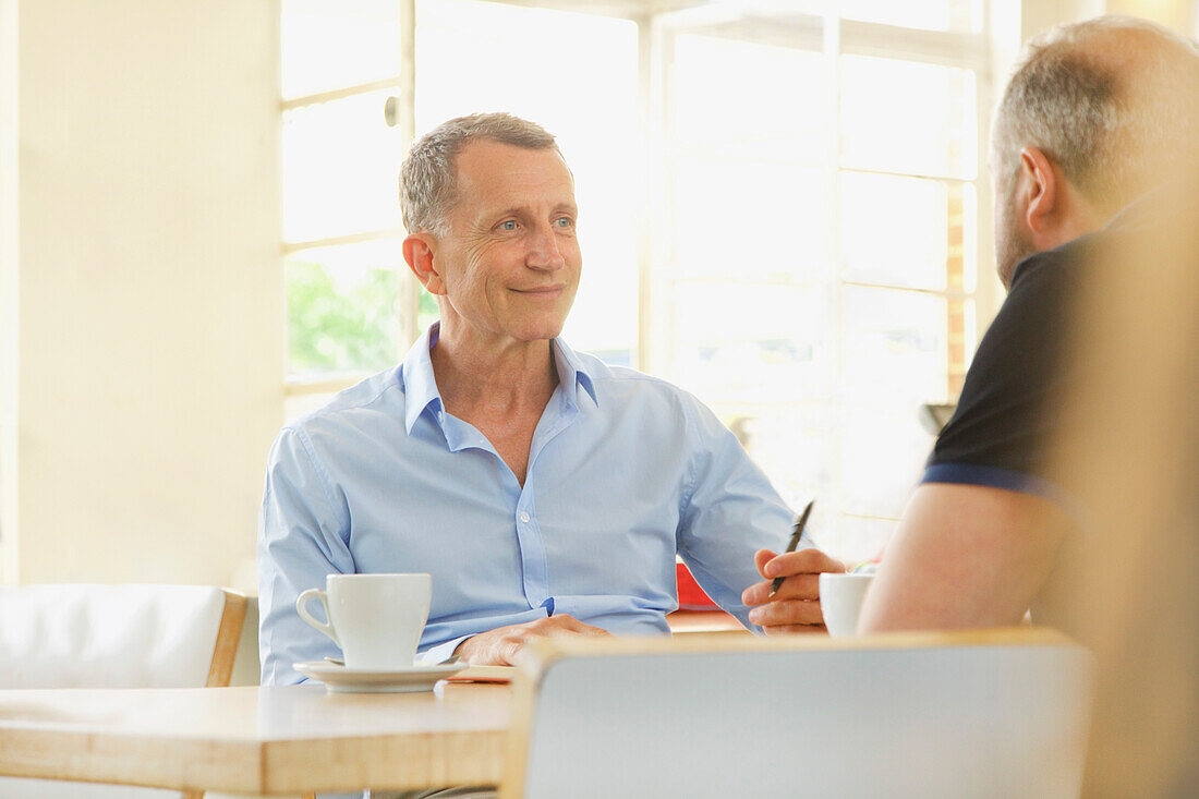 Two Business Men Having Meeting in a Restaurant