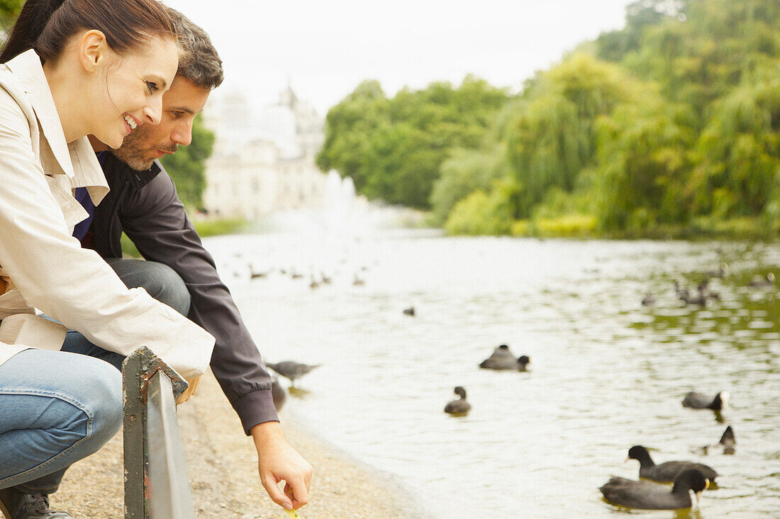 Couple Crouching by Lake St. James's Park, London, England