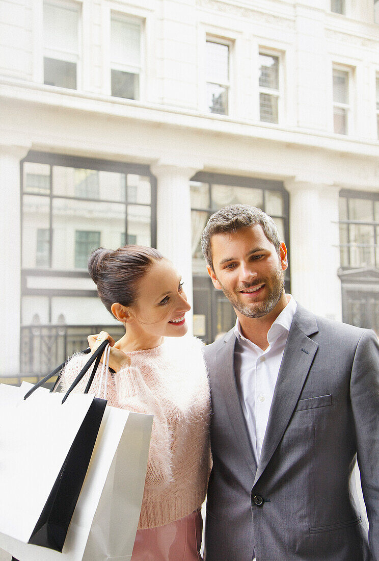 Smiling Couple on City Street with Shopping bags