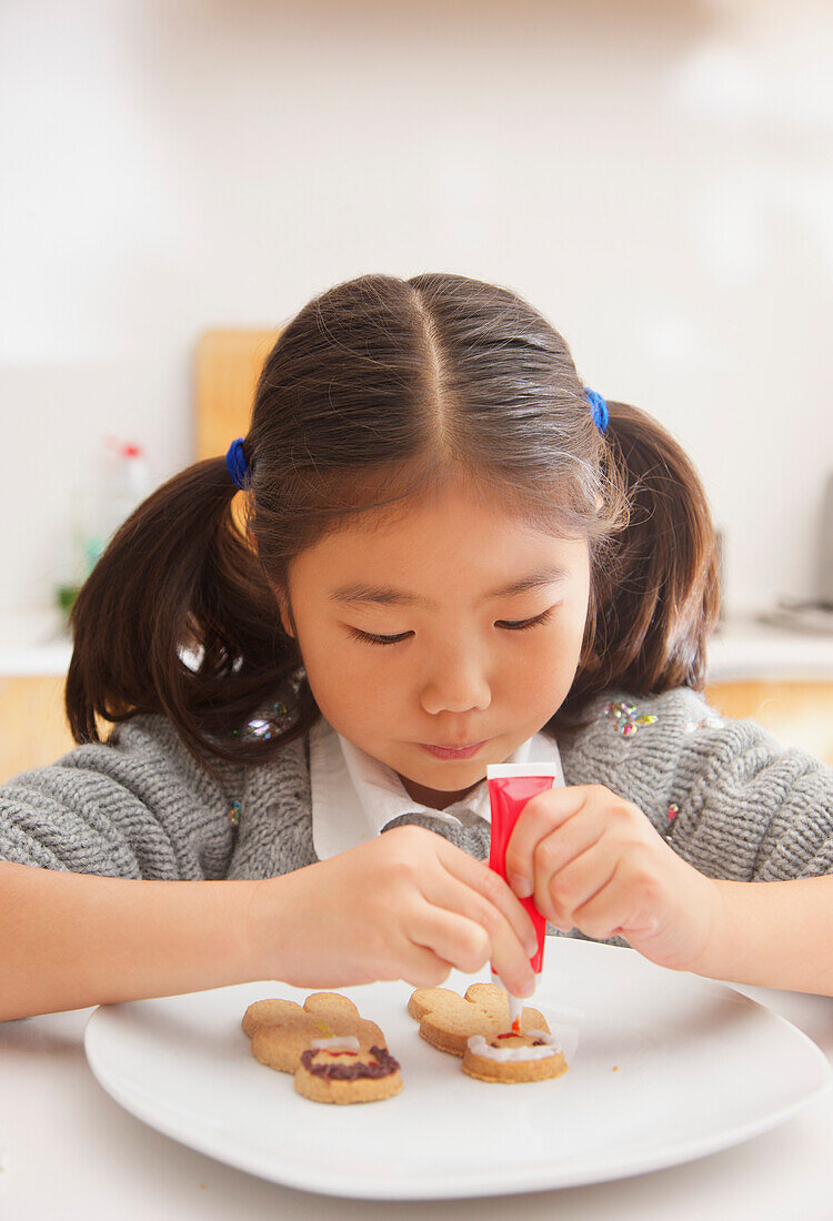 Young Girl Decorating Ginger bread man Biscuit