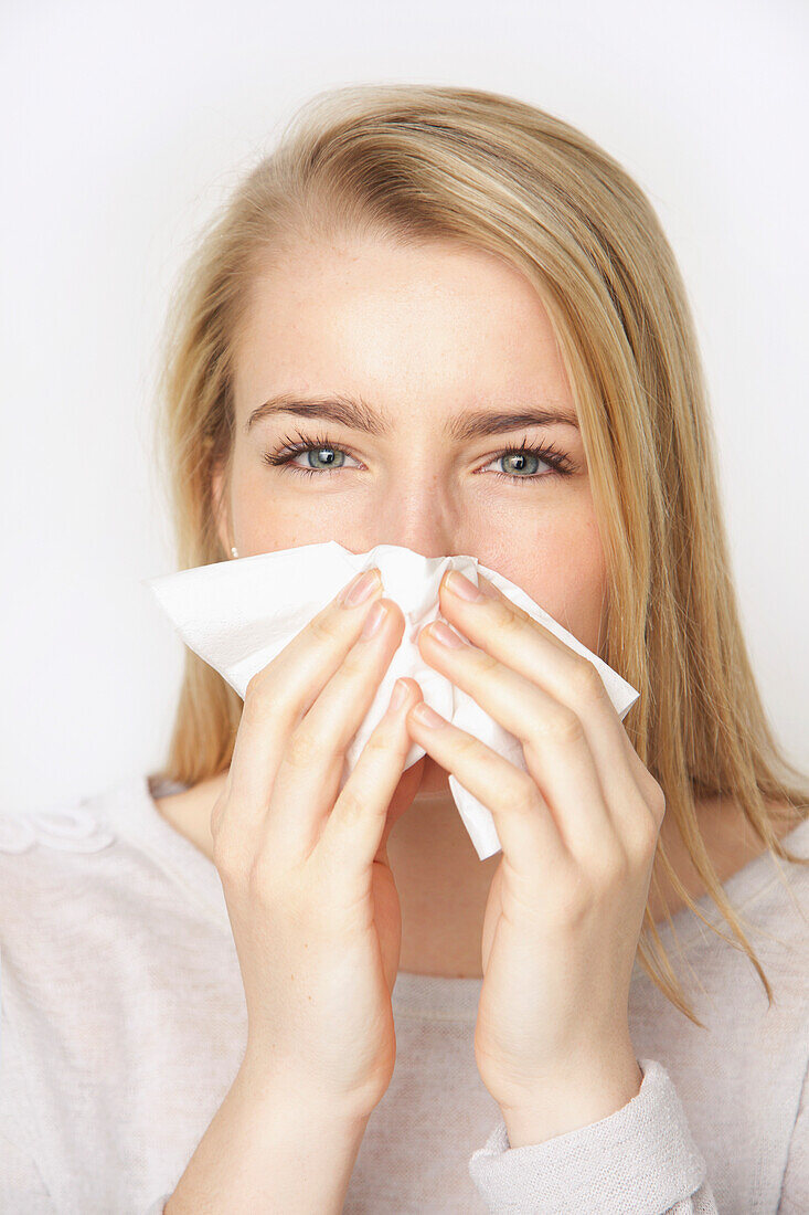 Young Woman Blowing her Nose