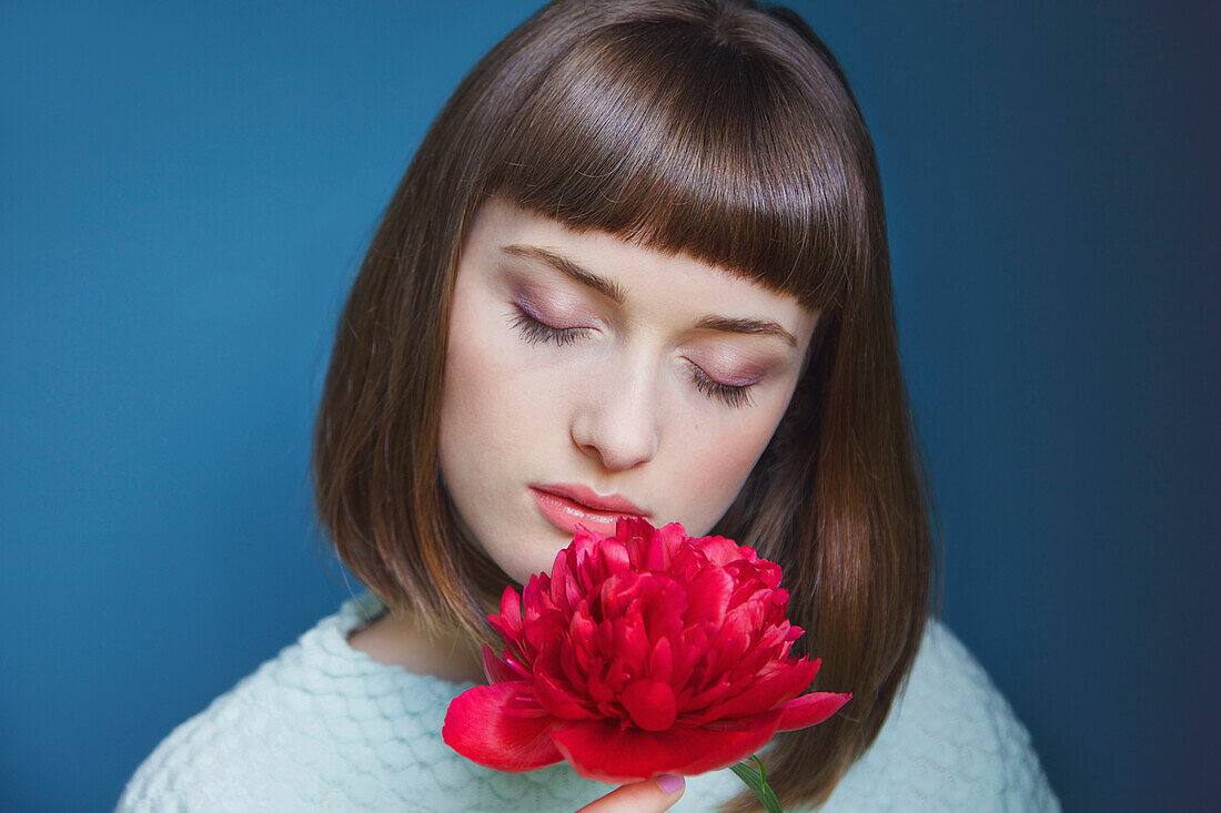 Close up of Teenage Girl Holding Red Peony