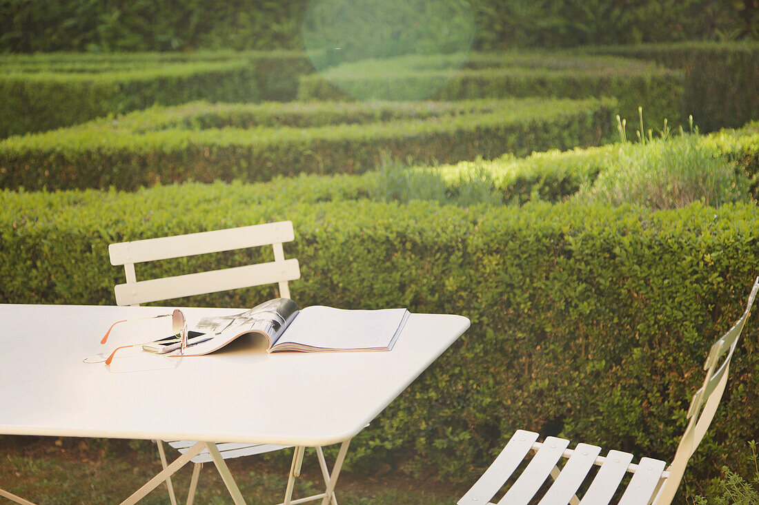 Magazine and Sunglasses on Table in Garden