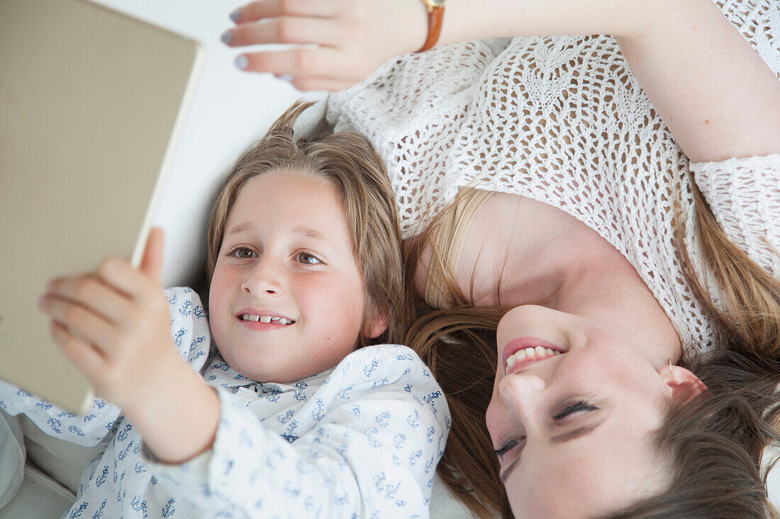 Boy and Teenage Girl Using Digital Tablet