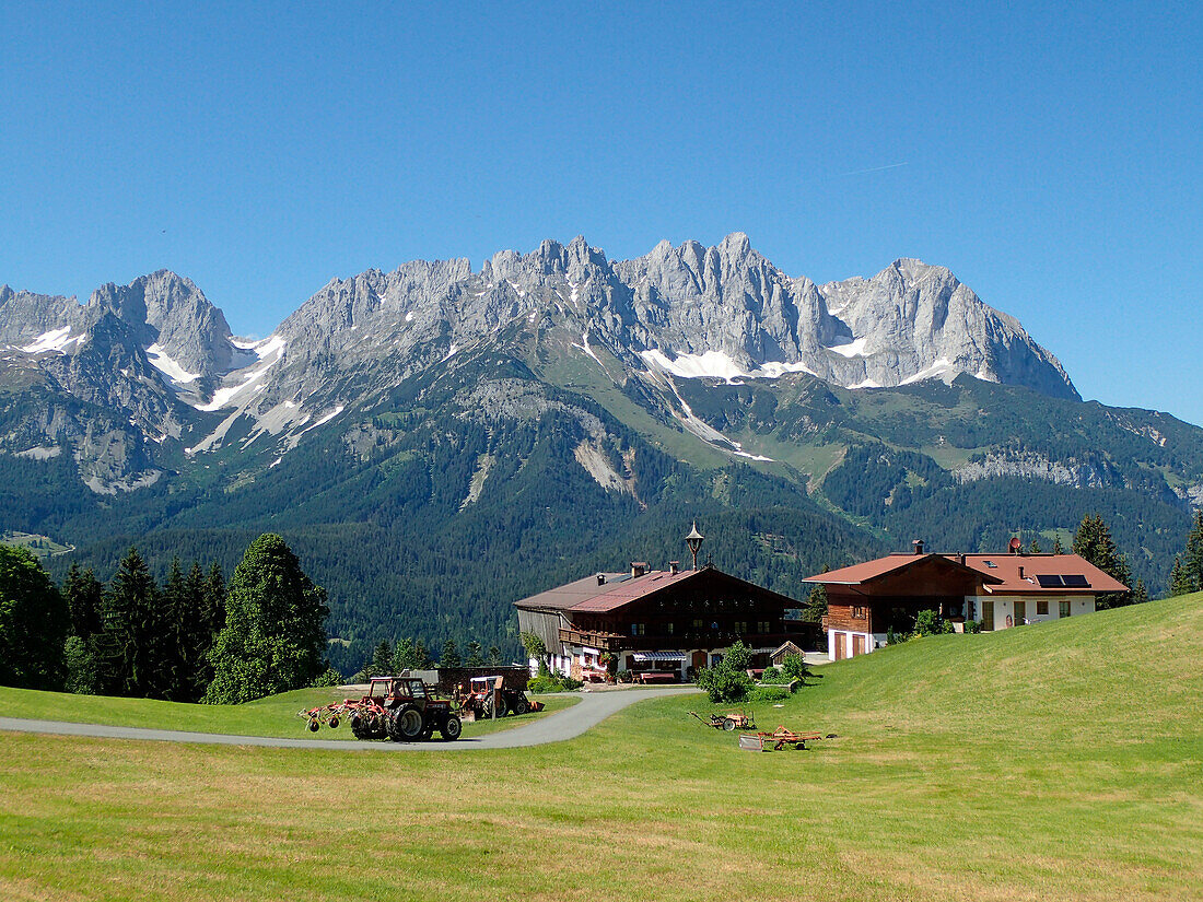 Austria,Tyrol,Kitzbuhel,traditional farm at Holenauerkreuz in front of the WILDERKAISER limestone range