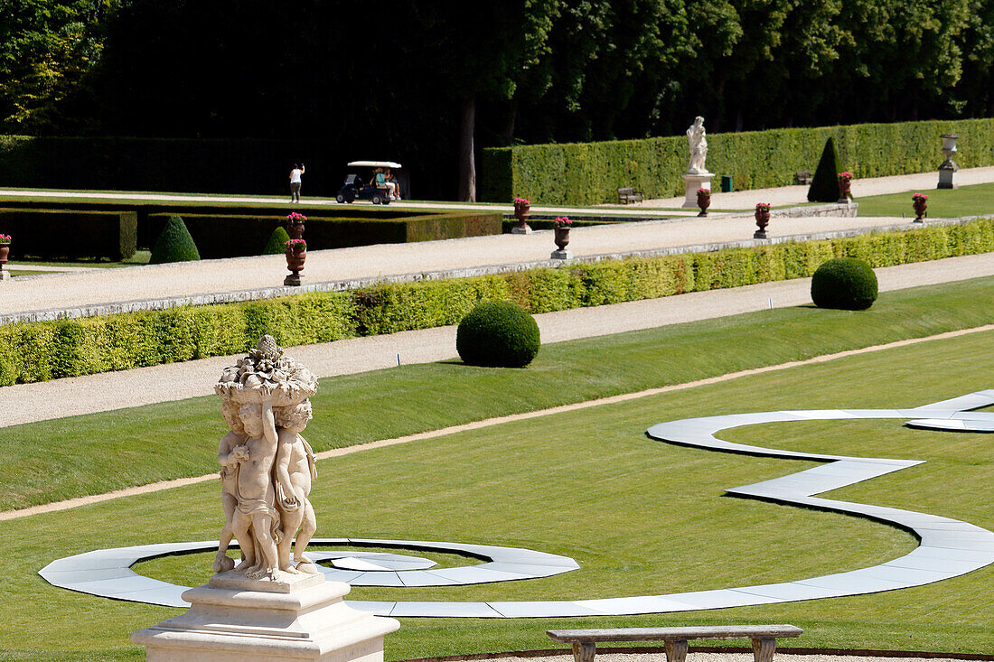 France. Seine et Marne. Castle of Vaux le Vicomte. The gardens. On the back a tourist doing a selfie.