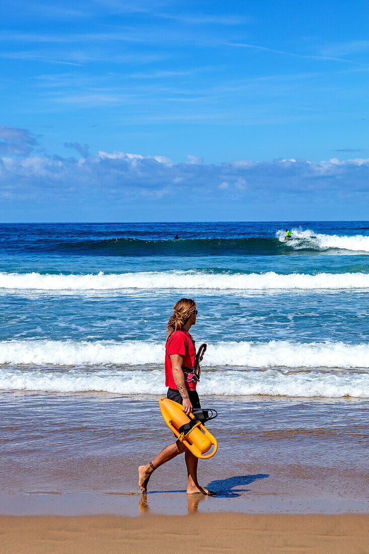 San Sebastian,Spain - September 07,2019 - View of a lifeguard supervising surfers