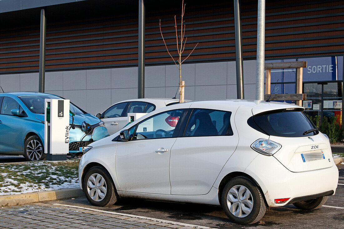 France. Seine et Marne. Coulommiers region. Commercial zone. Electric Renault Zoe cars charging at a free Schneider Electric EVLINK terminal.