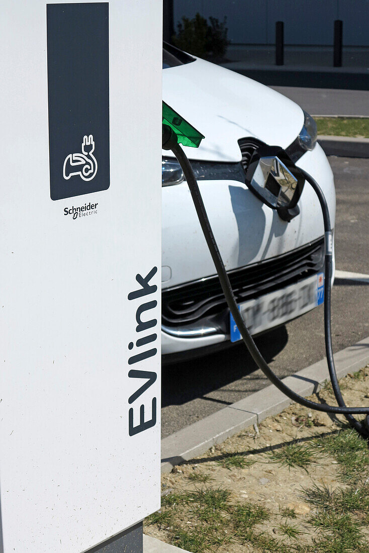 France. Seine et Marne. Coulommiers region. Renault Zoe electric car charging at a free Schneider Electric terminal in a shopping center.