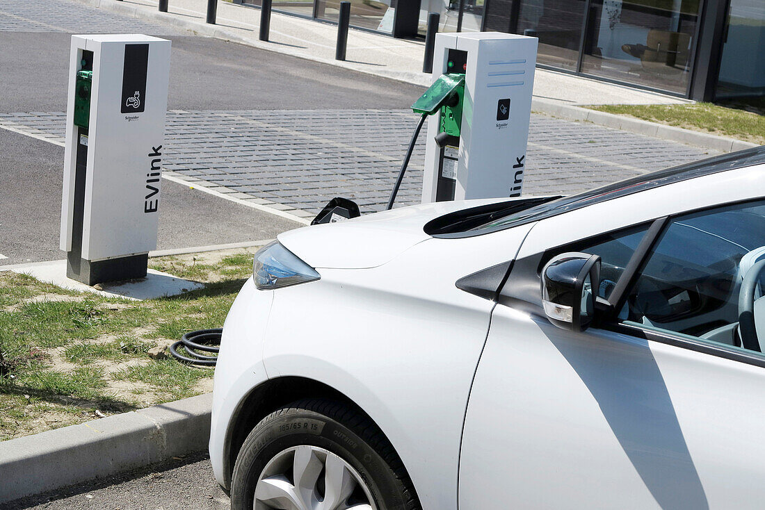 France. Seine et Marne. Coulommiers region. Renault Zoe electric car charging at a free Schneider Electric terminal in a shopping center.