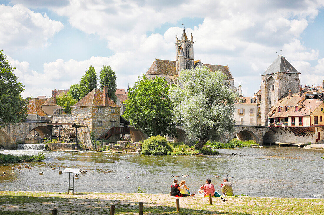 France. Seine et Marne. Medieval village of Moret sur Loing. Residents resting on the banks.