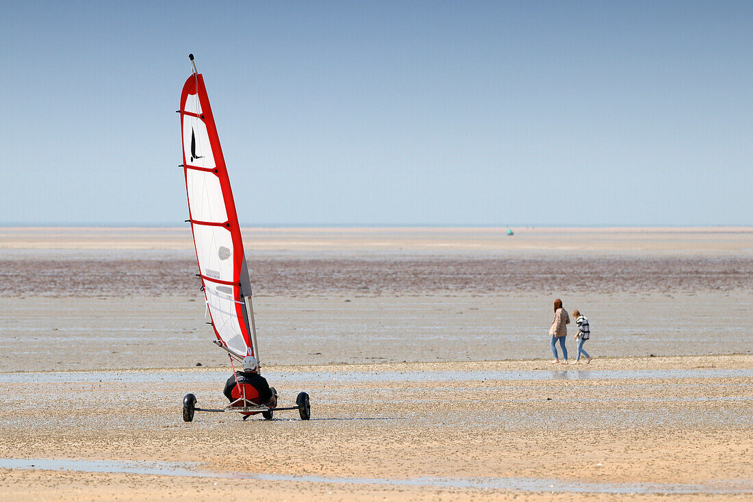 France. La Manche. Hauteville sur Mer at low tide. Spring school vacation period. Tourists walking on the beach.