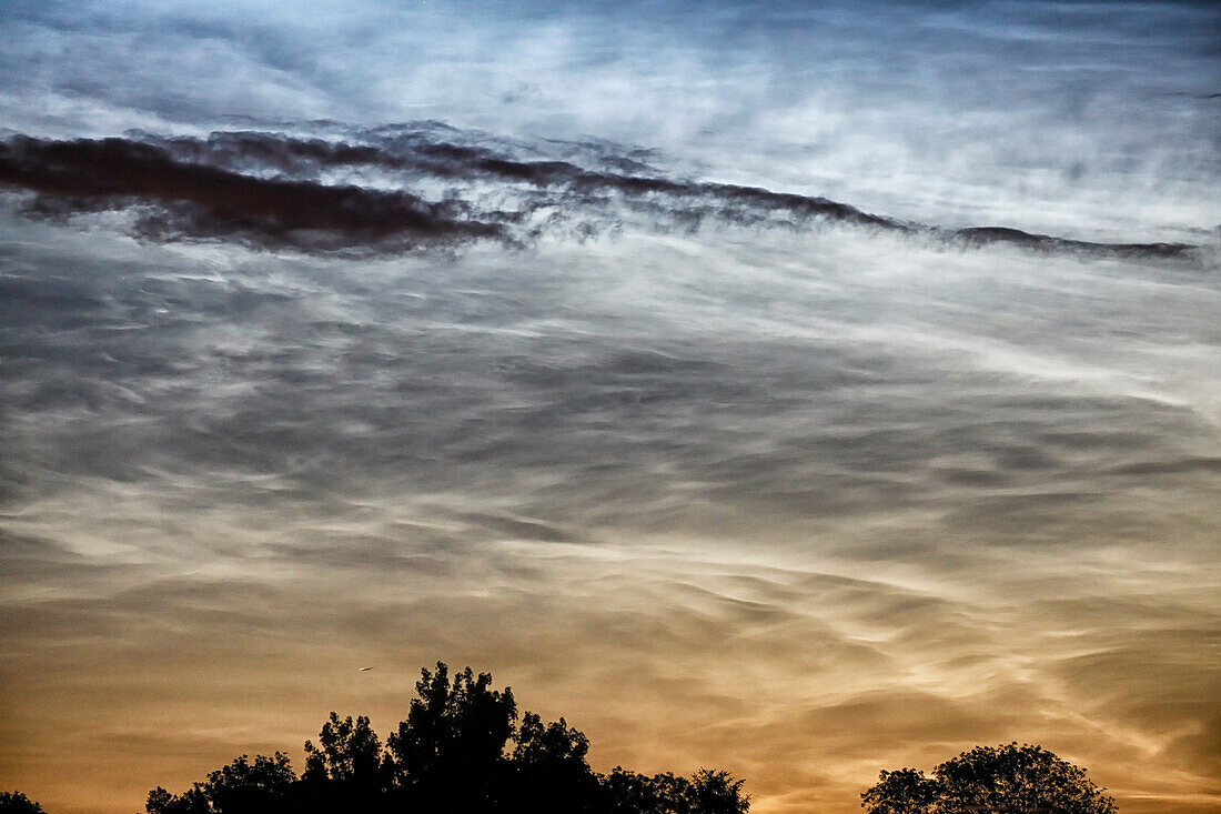 France. Seine et Marne. Coulommiers region. Noctilucent clouds visible in the sky at the beginning of the night on June 18,2021. These clouds are composed of ice and are located at the limit of space (about 80 km altitude).