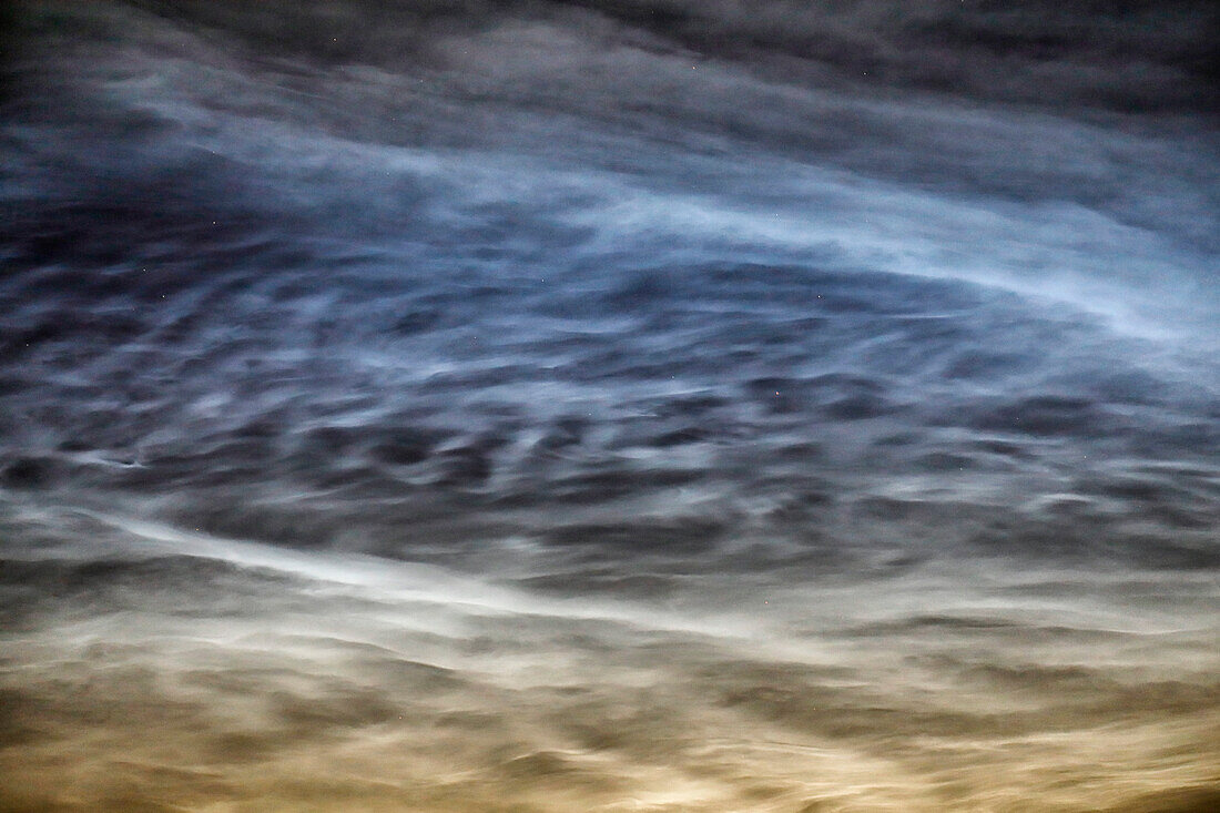 France. Seine et Marne. Coulommiers region. Noctilucent clouds visible in the sky at the beginning of the night on June 18,2021. These clouds are composed of ice and are located at the limit of space (about 80 km altitude).