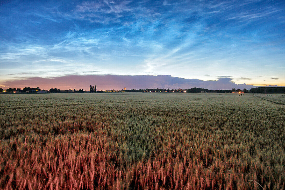 France. Seine et Marne. Coulommiers region. Noctilucent clouds visible in the sky at the beginning of the night on June 21,2021. These clouds are composed of ice and are located at the limit of space (about 80 km altitude). Thunderstorms developing