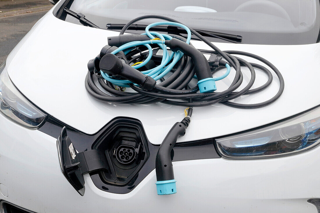 France. Seine et Marne. Electric car Renault Zoe. Close up on many charging cables (classical 220v,types 2 and 3),showing the complexity of cables choice.