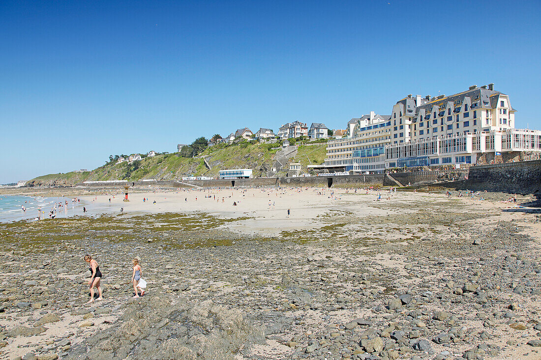 France. Normandy. Department of Manche. Granville during the summer. View from the coast and part of the beach. Le Normandy rehabilitation center. Tourists on the rocks.