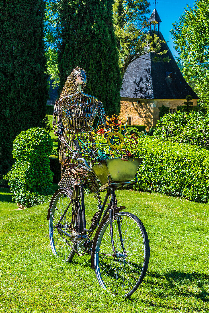 France,Perigord Noir,Dordogne,Jardins du Manoir d'Eyrignac (Historical Monument) sculpture by Pierre Treilhec (Femme au velo) temporary exhibition,April-October 2019