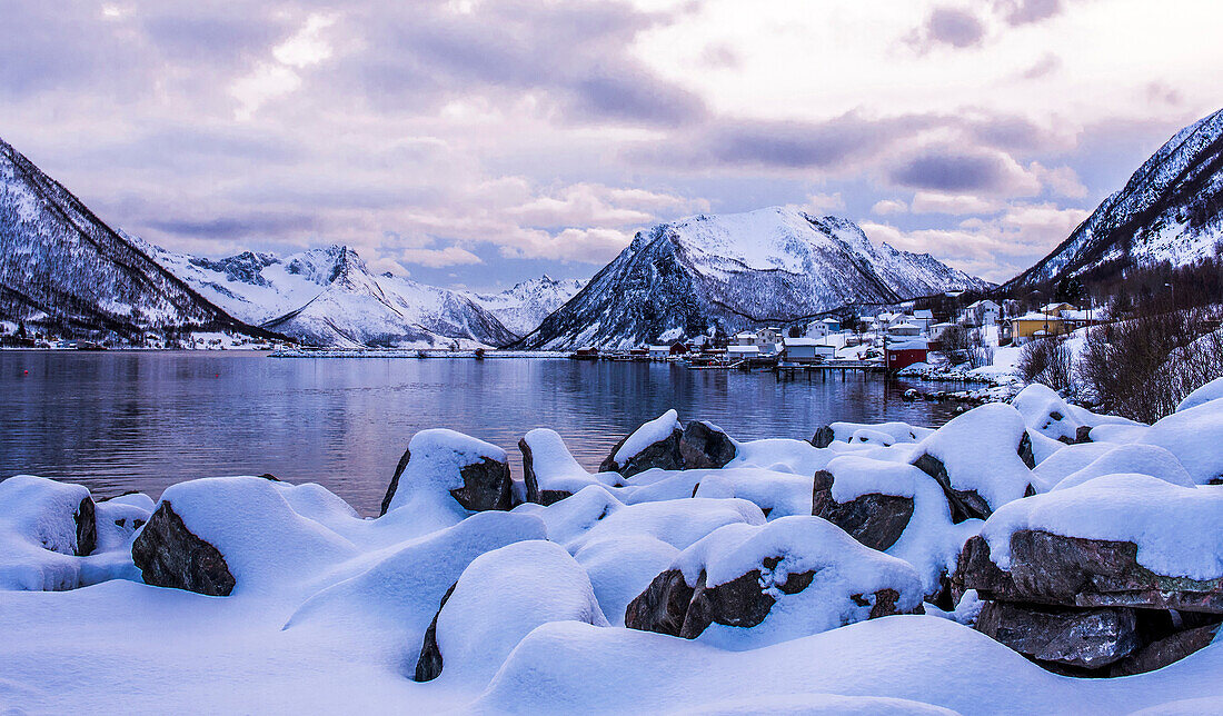 Norway,city of Tromso,Island of Senja,fjord covered with snow at sunset