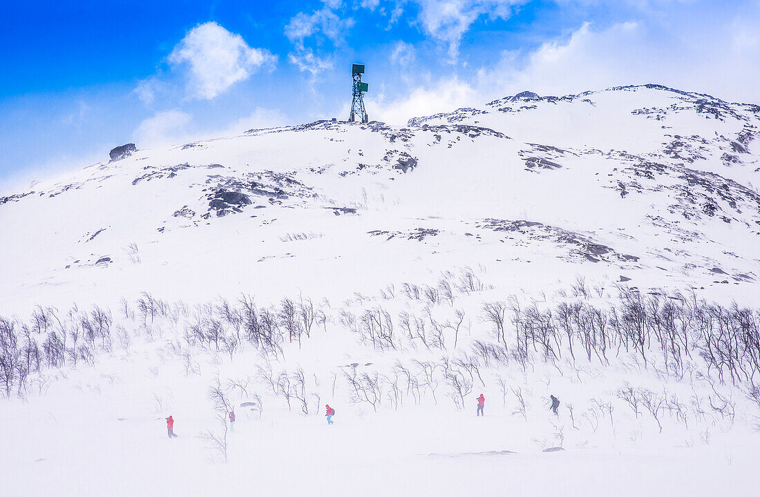 Norway,city of Tromso,Island of Senja,snowy landscape and hikers